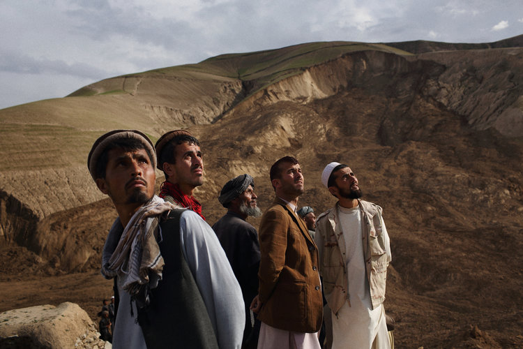  Watching the Vice President depart by helicopter from the site of a landslide—which can be seen in the background—that buried as many as 300 homes and hundreds of residents 24 hours prior. Badakhshan Province, May, 2014. 