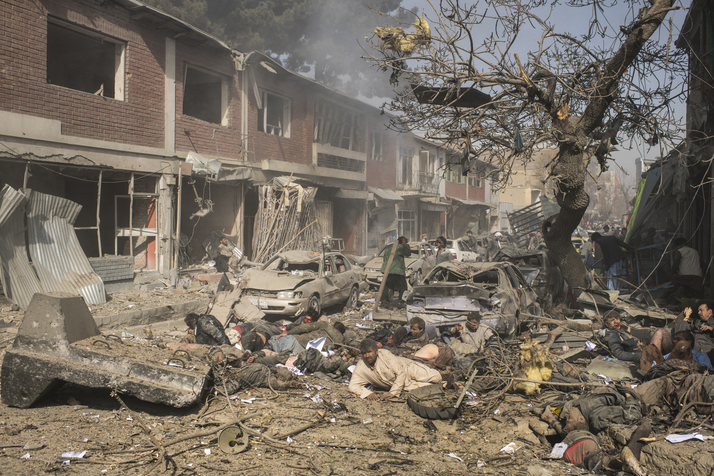  Victims lie dead and severely wounded at the site of a bomb that had been disguised inside an ambulance and detonated in an area of small businesses and a hospital in central Kabul. 103 were killed and more than 150 wounded by the bomb for which the Taliban claimed responsibility. Kabul, January, 2018. 